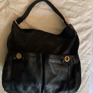 Marc Jacobs black leather handbag with two front pockets and snap closure